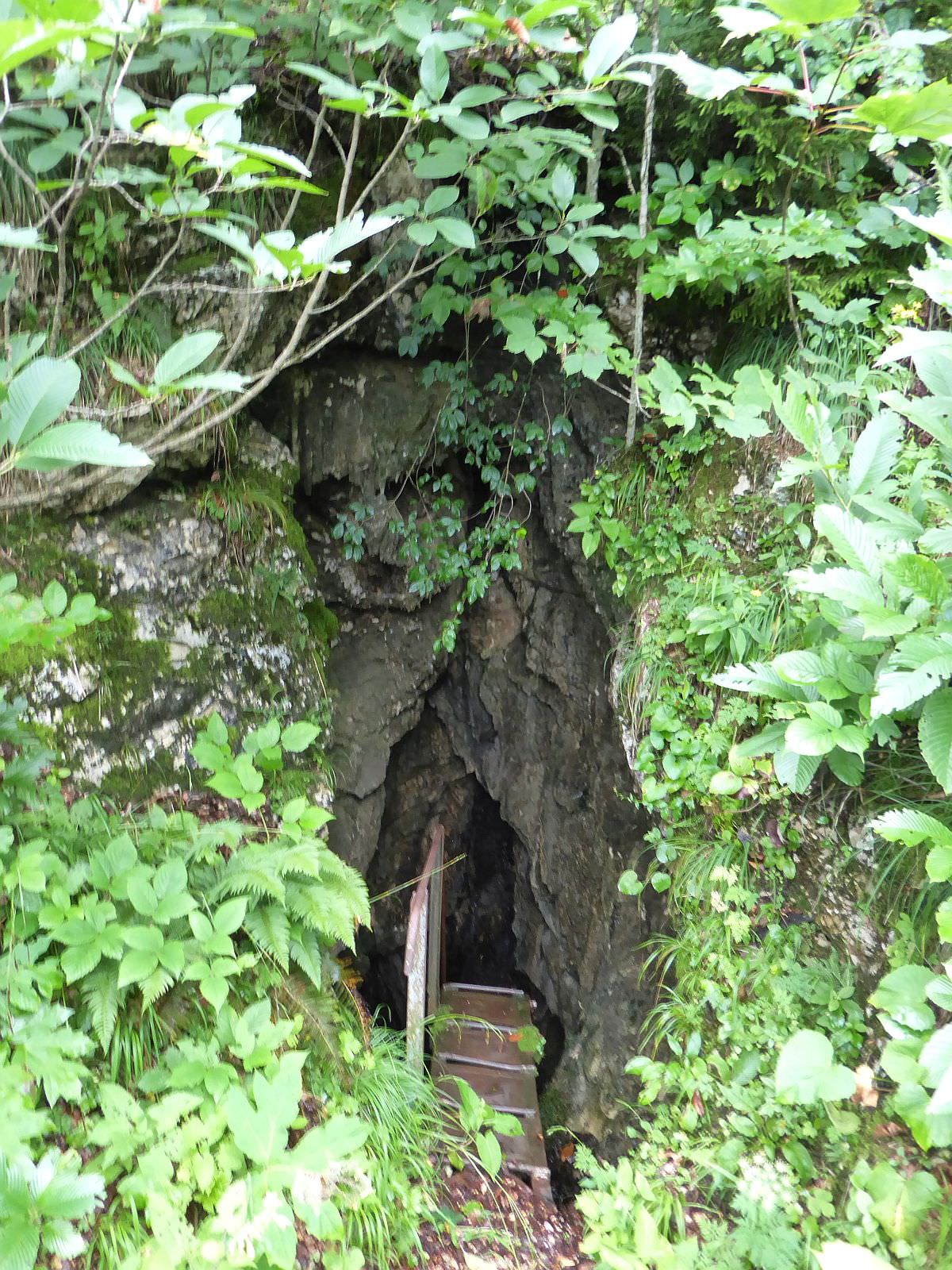 Entrance to the cave with a water spring